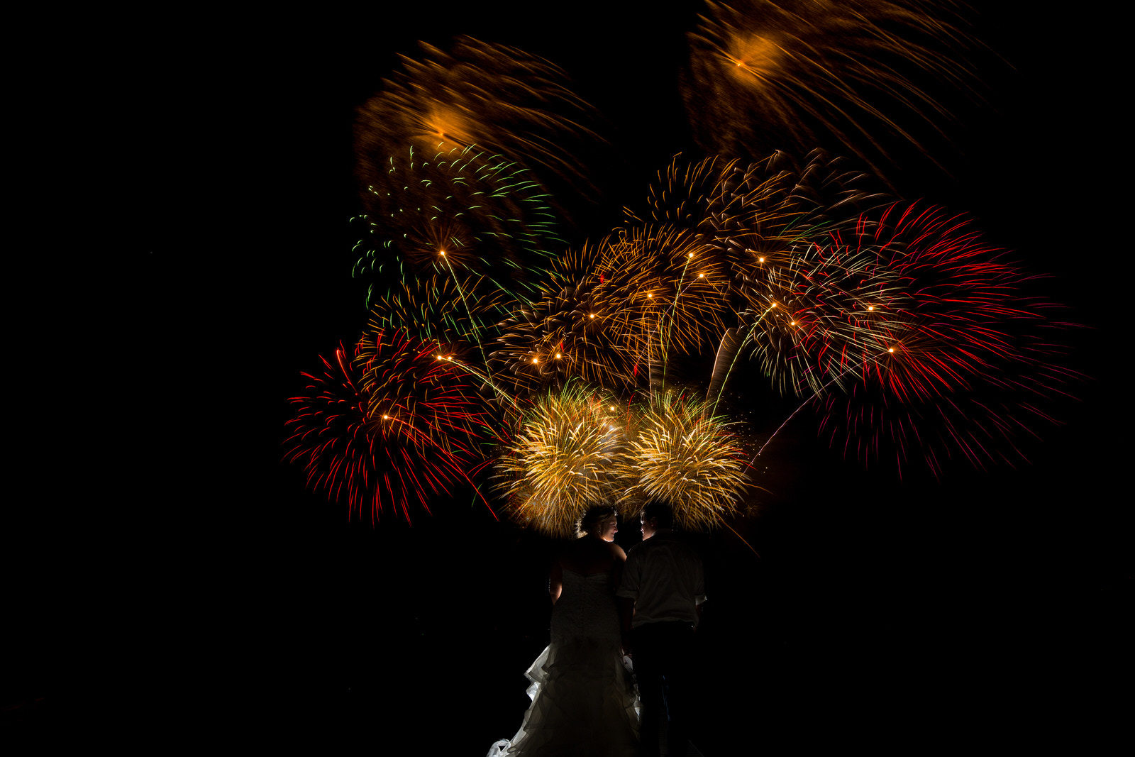 Lakeside Glenwood Wedding couple with fireworks