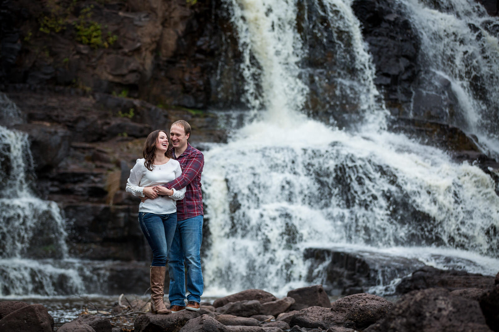 Gooseberry Falls Engagement Session waterfall portrait with happy couple