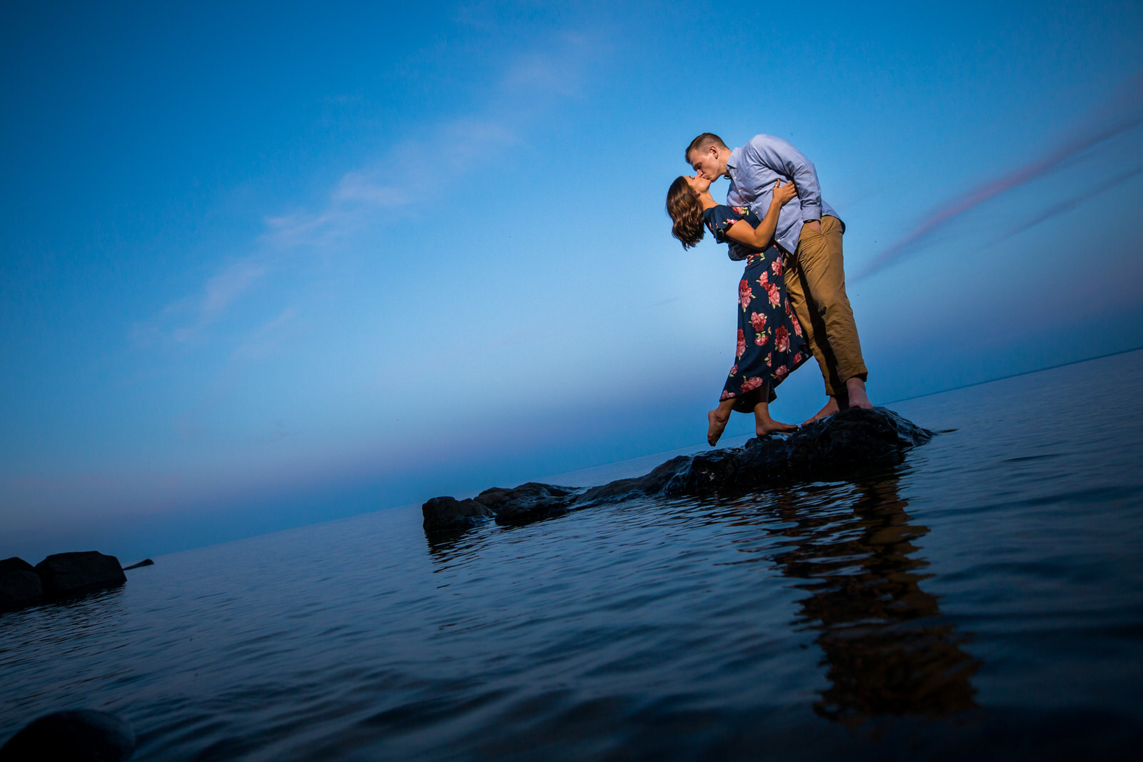 Duluth Summer Engagement Session couple in the lake at sunset