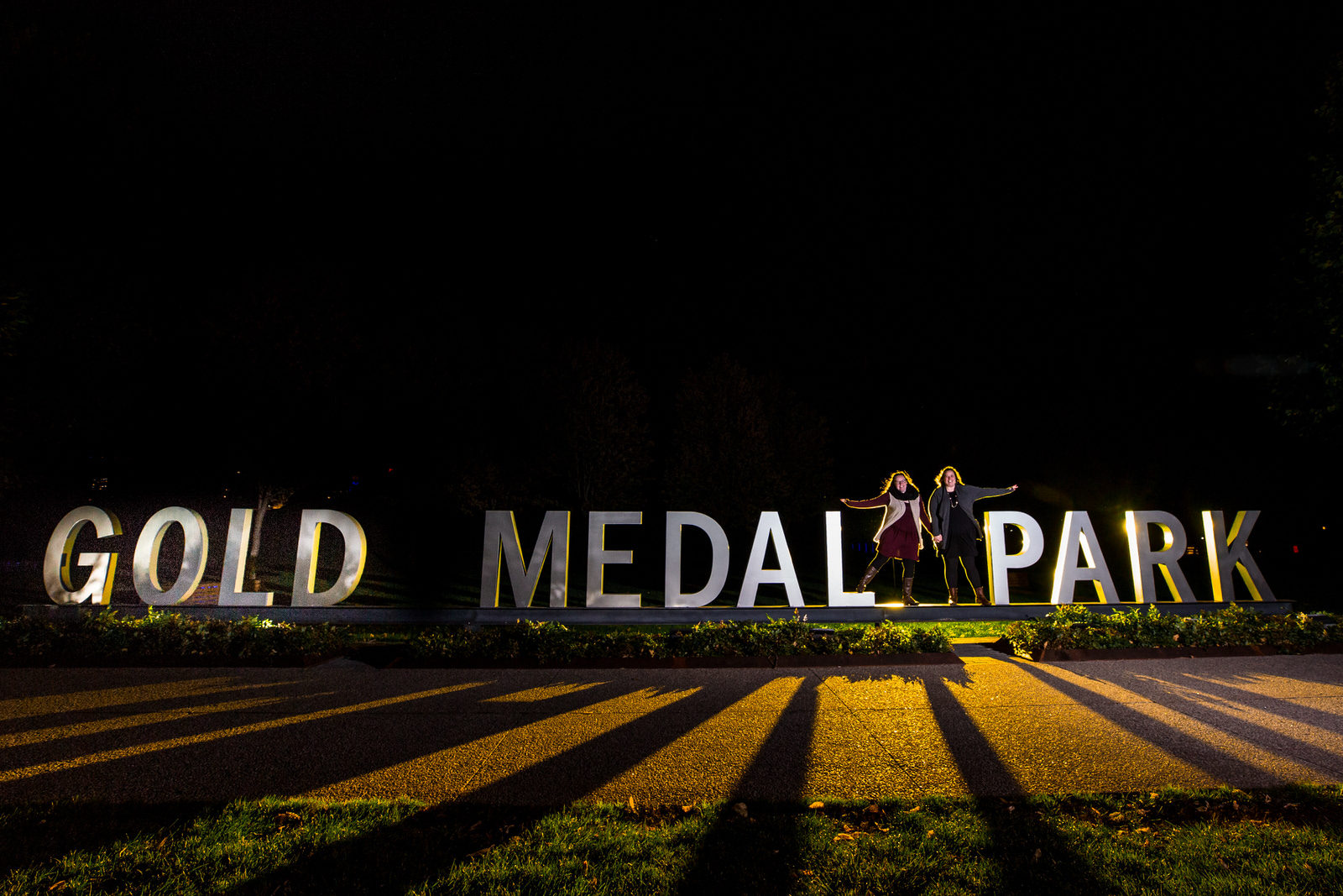Park Engagement Session couple with gold medal park sign