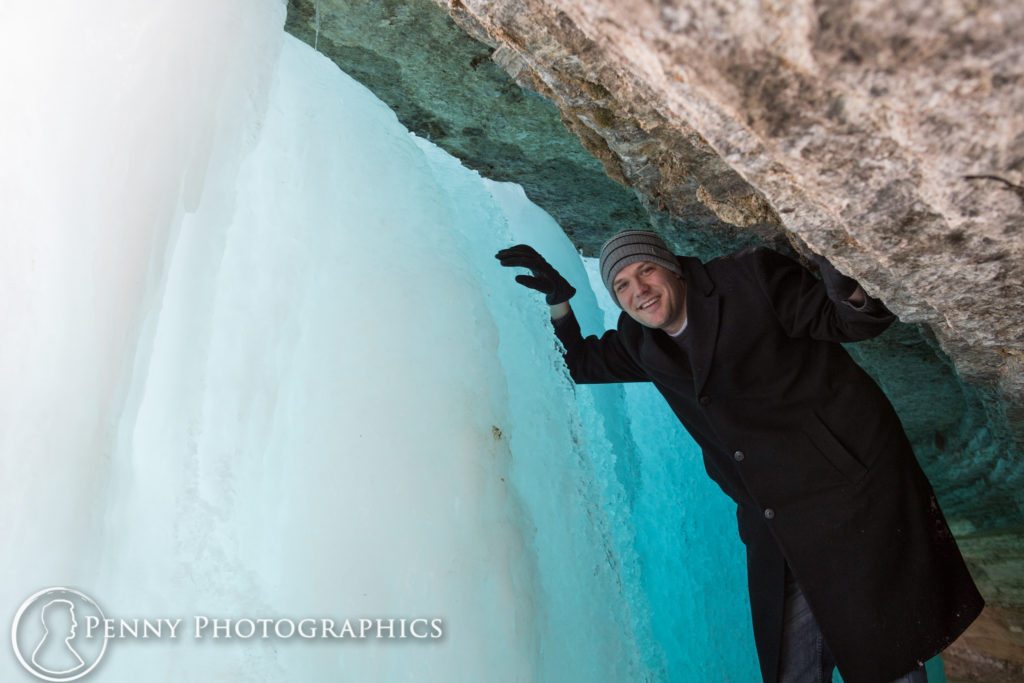 Minnehaha Frozen Falls Adventure leaning against frozen wall of water