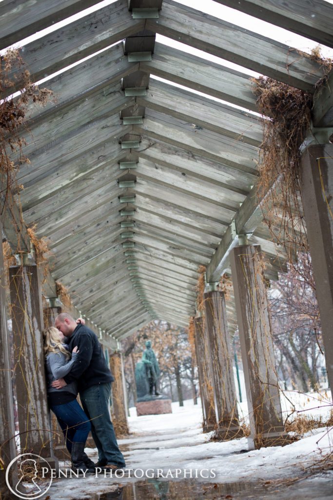 Frozen Falls Engagement couple kiss in a timber pavilion