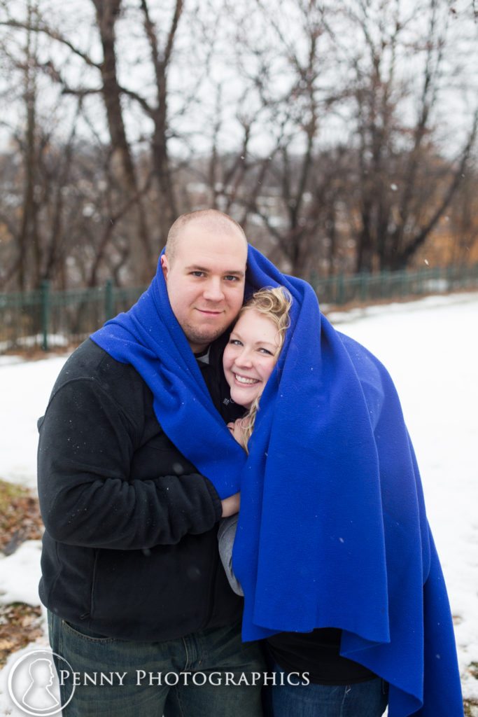 Frozen Falls Engagement couple snuggle under blanket