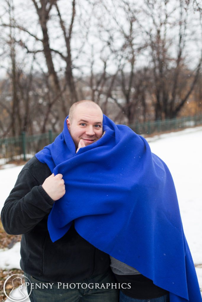 Frozen Falls Engagement couple keep warm under a blanket