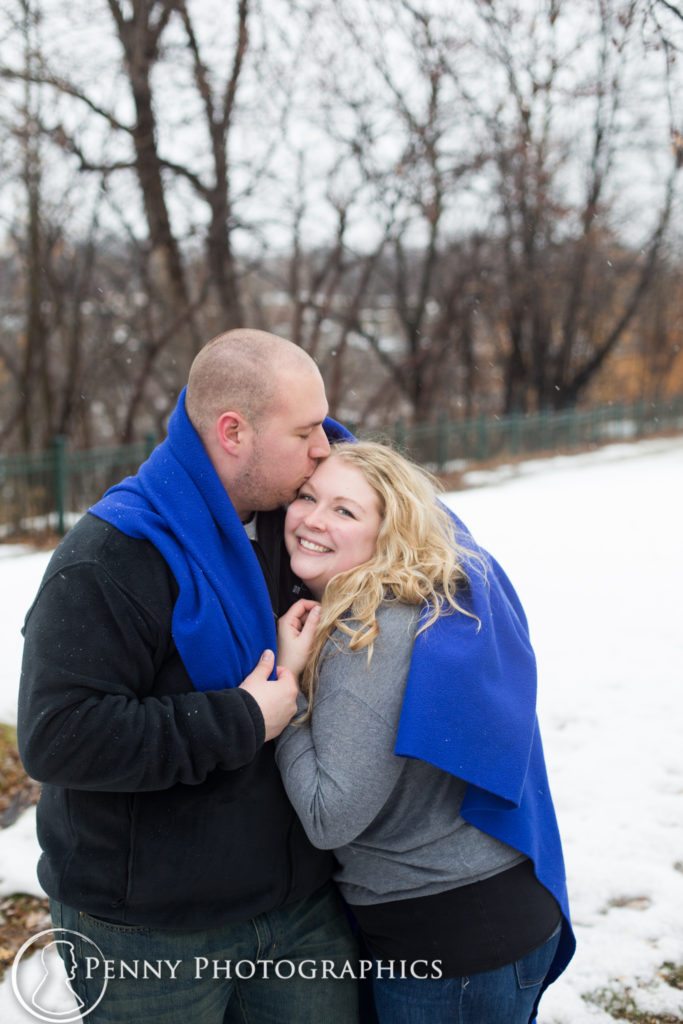 Frozen Falls Engagement couple kiss under a blanket
