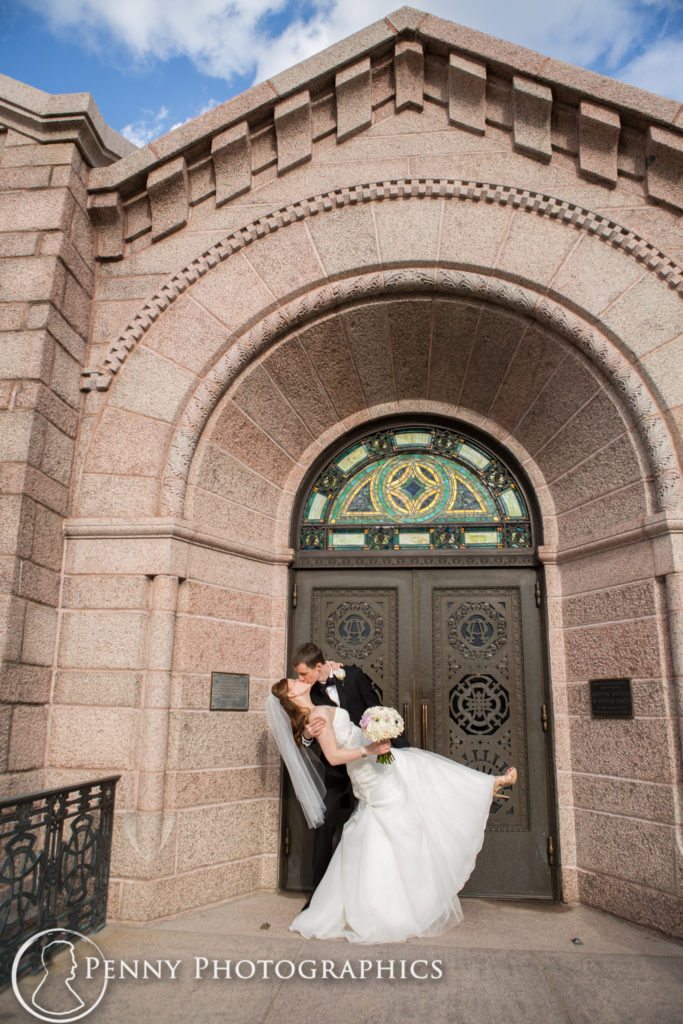 groom dipping bride outside church