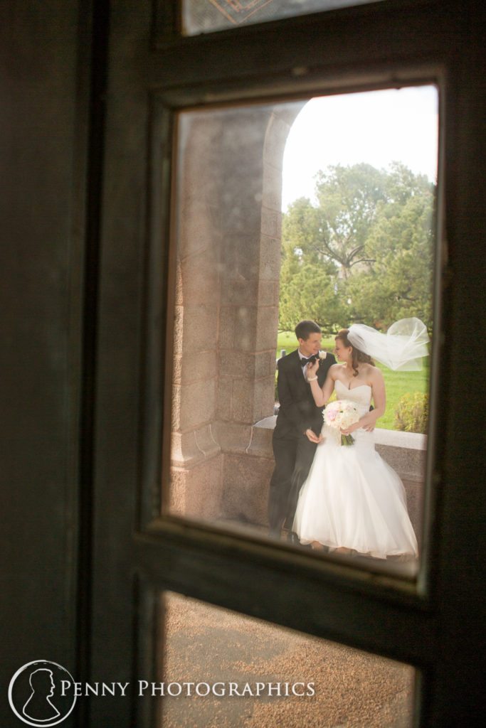 bride and groom through window at wedding in Minneapolis