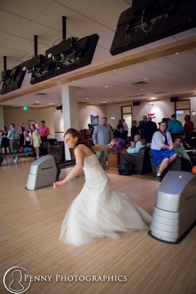bride in wedding dress bowling at pinstripes in Minnesota