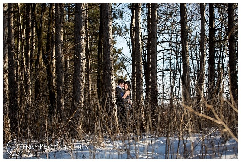 Winter Adventure Engagement couple in the trees