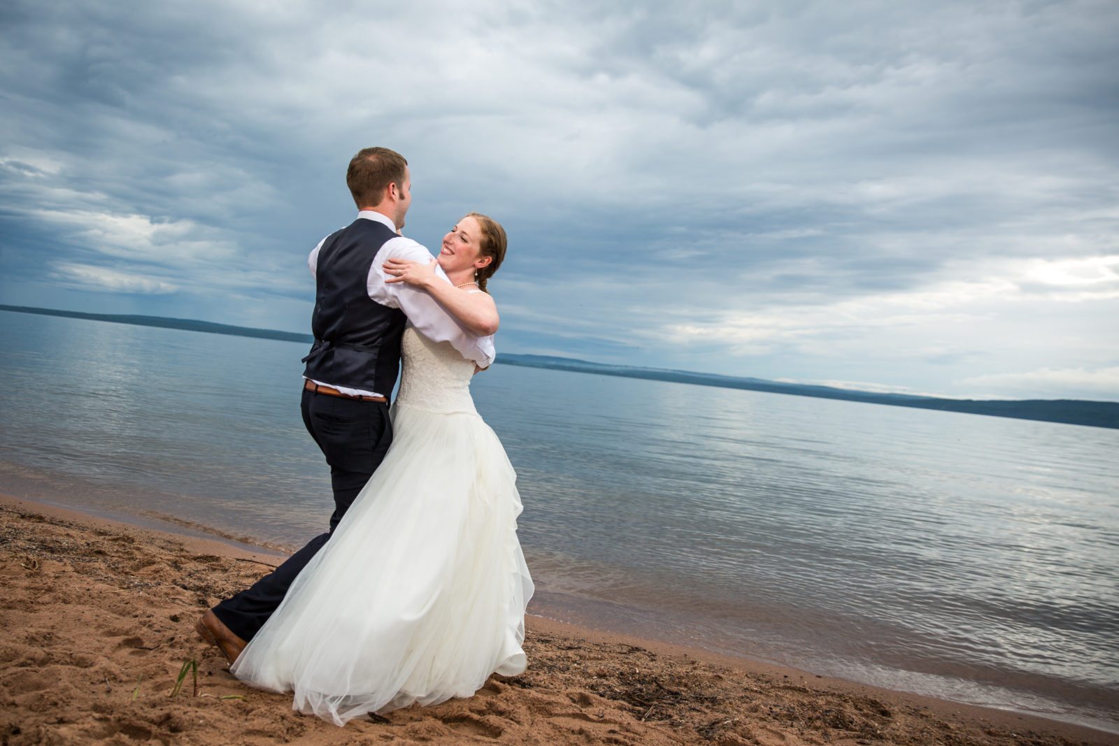 Madeline Island Wedding couple dancing on beach