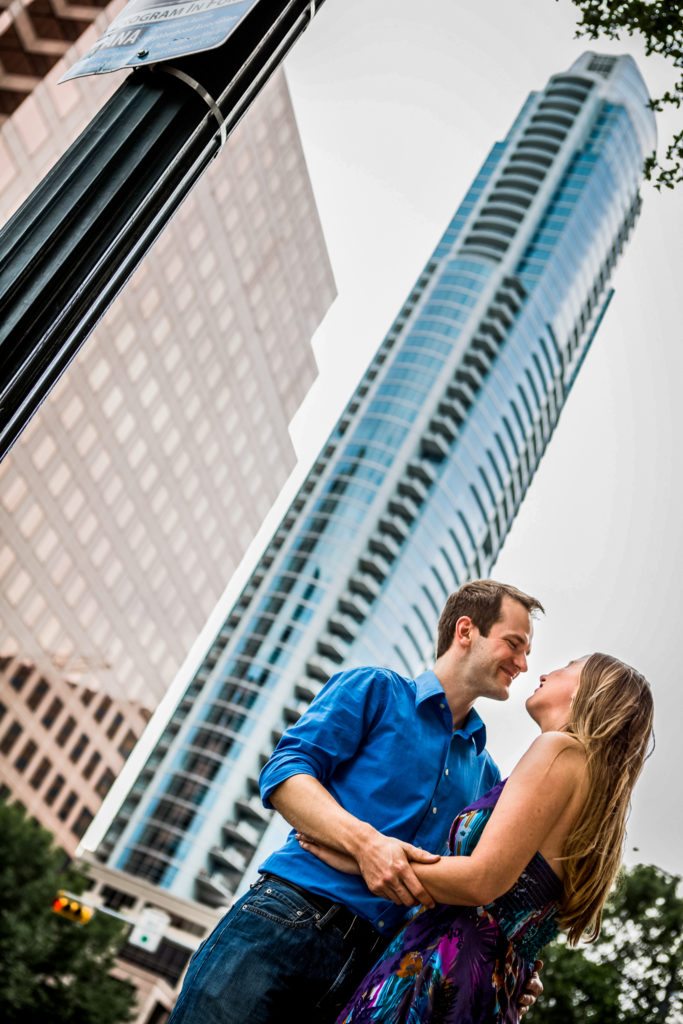 Austin urban engagement couple against skyline