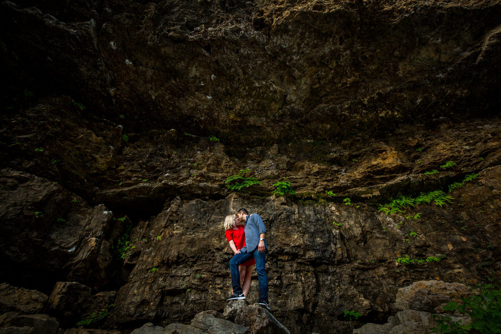 waterfall engagement couple against rock wall
