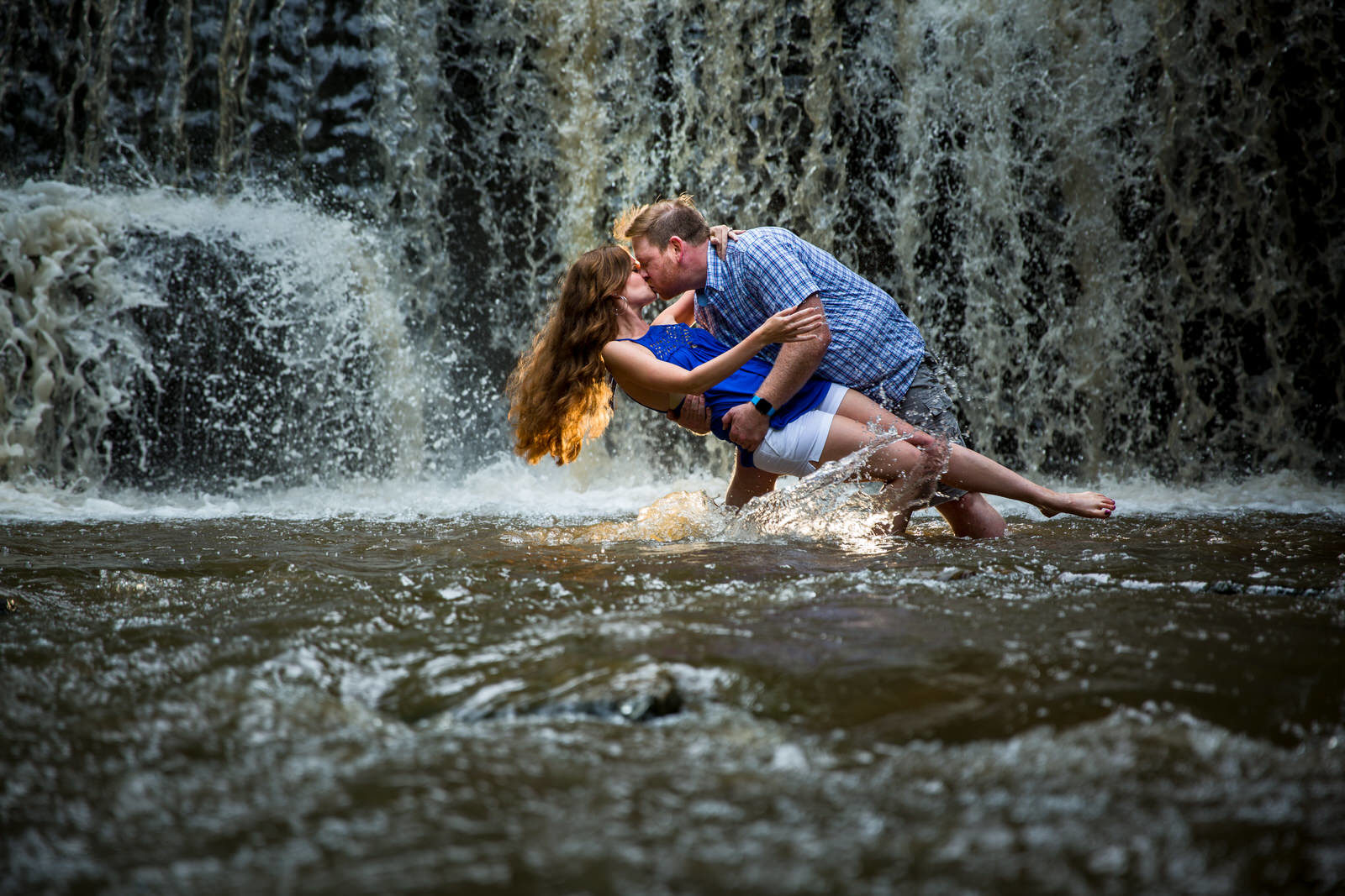 Minneapolis Engagement couple dips in waterfall