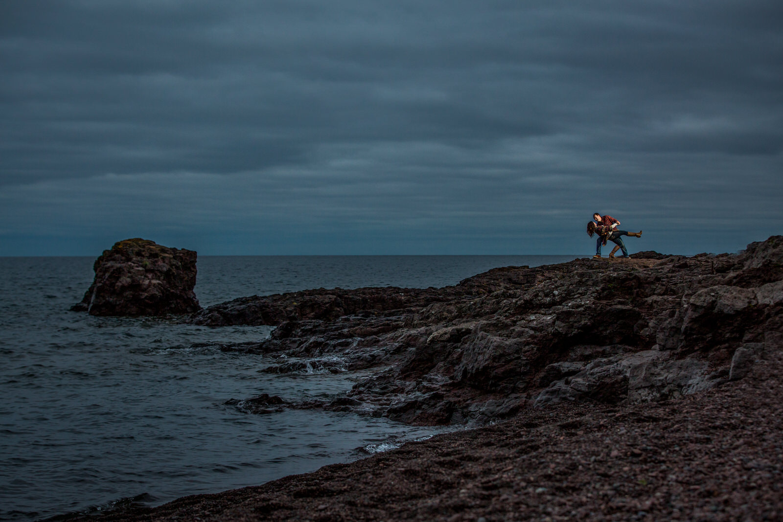 Gooseberry Falls Engagement Session couple dips by dramatic coastline