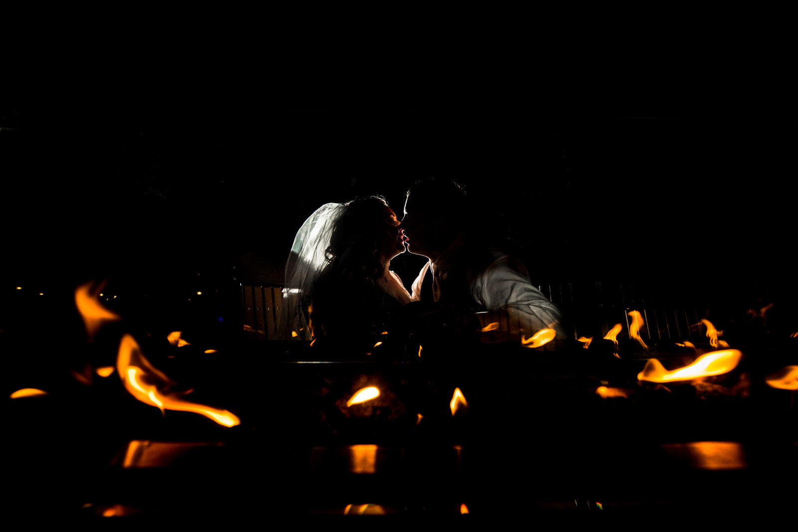 Earle Brown Wedding couple kissing in the flames