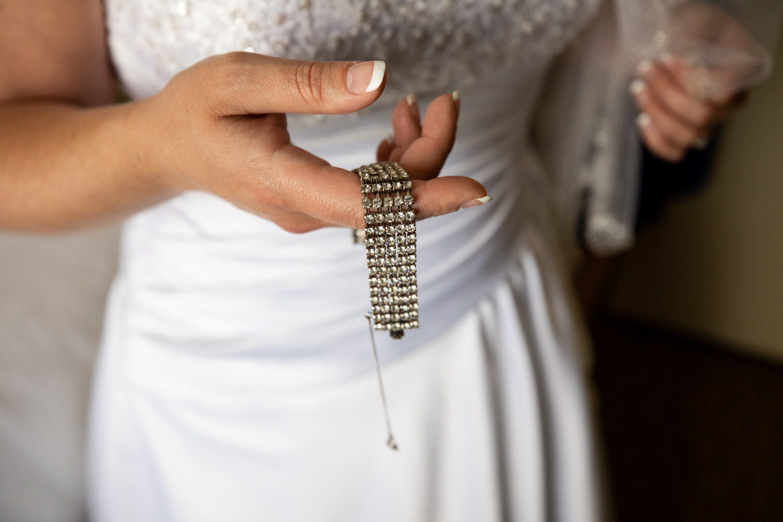 Earle Brown Wedding bridge holding wedding jewelry