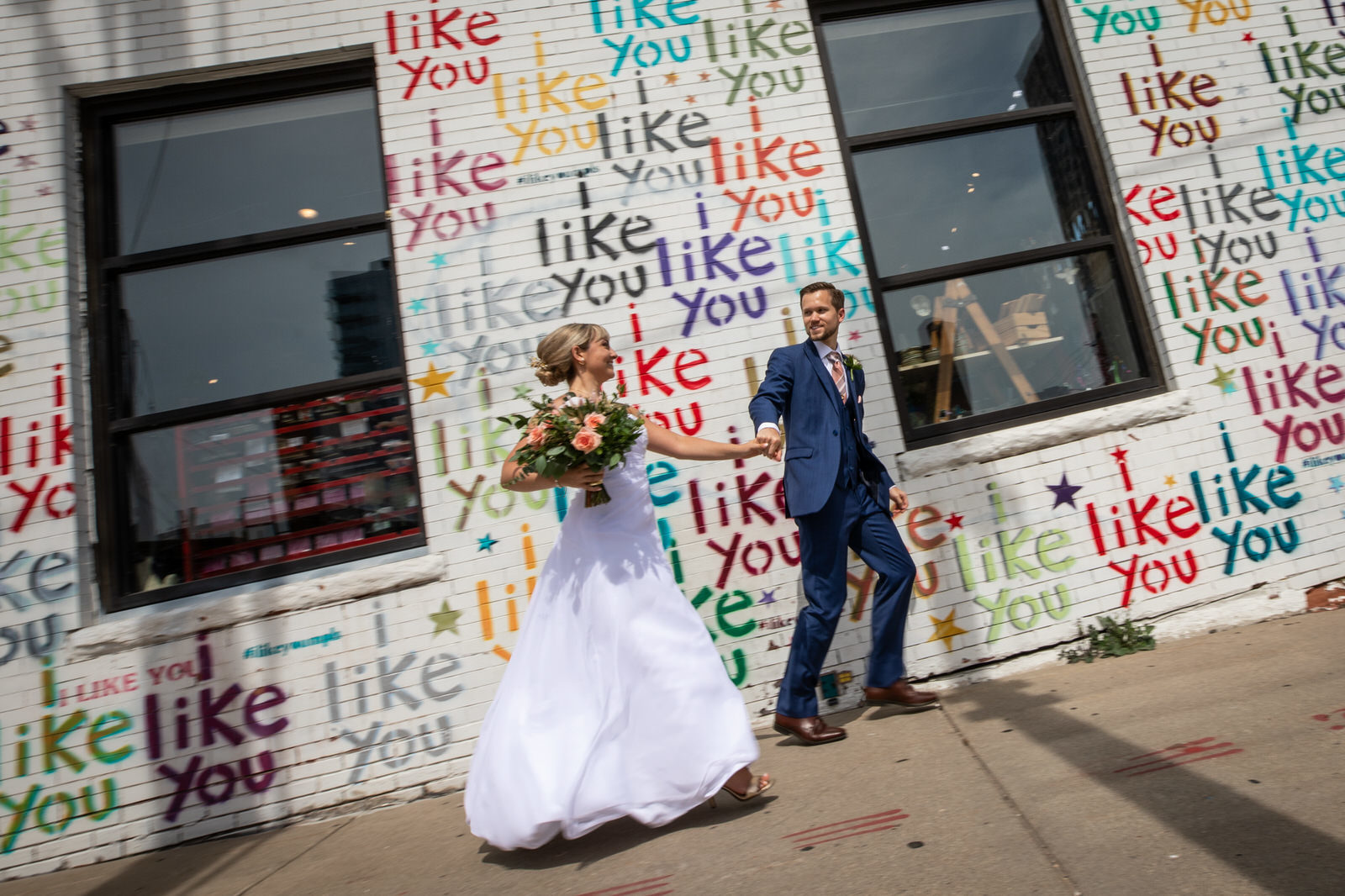 Couple in front of I Like You wall