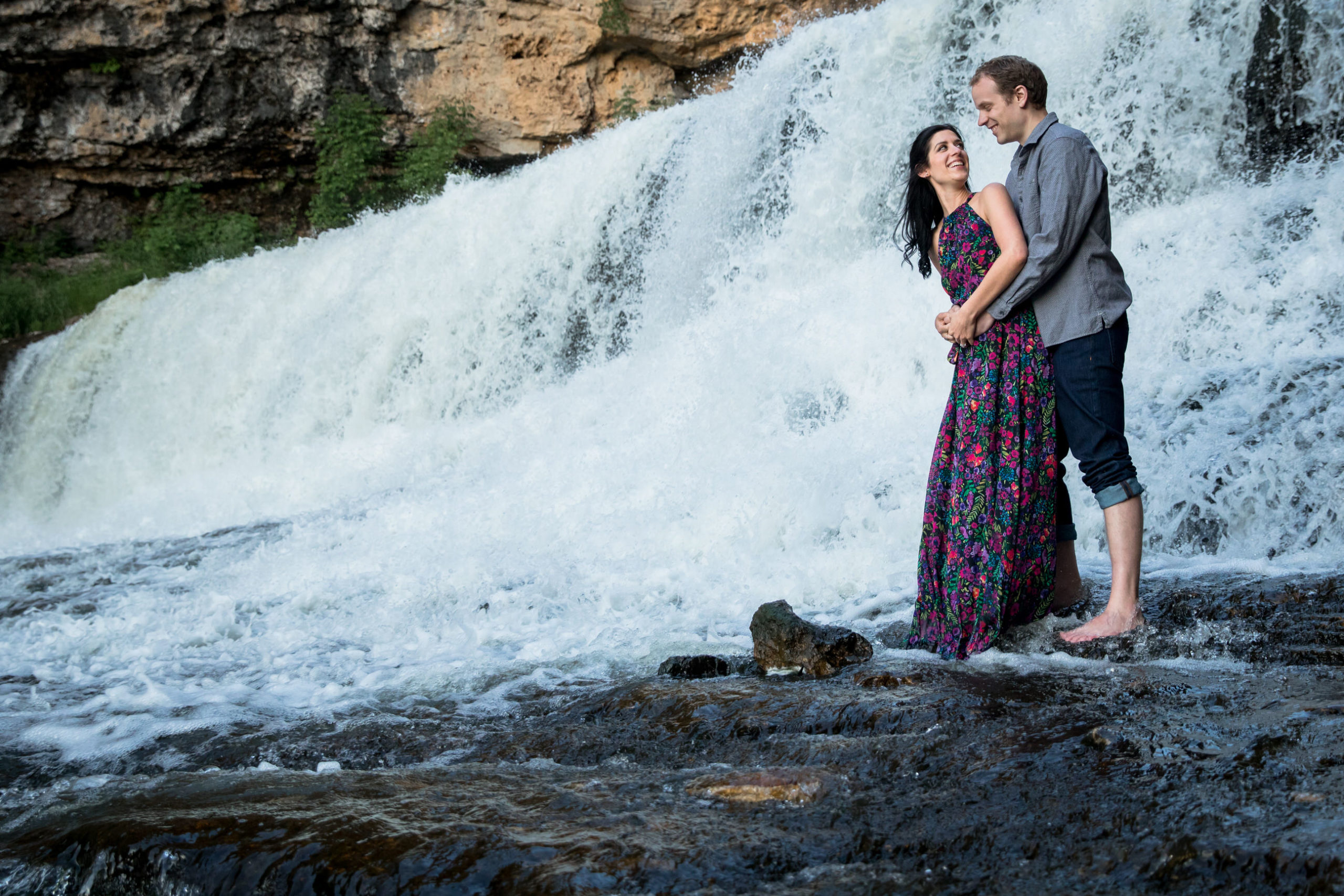 playing in a waterfall summer engagement session