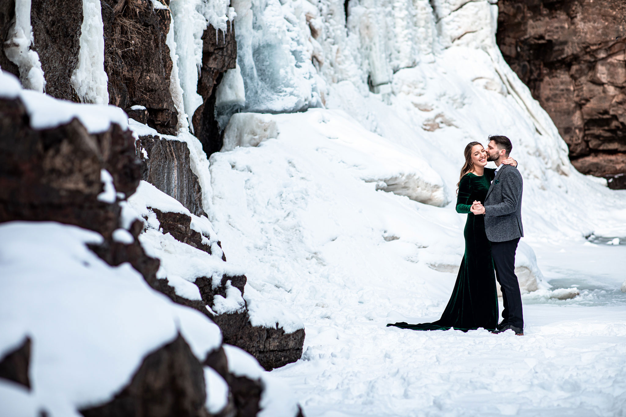 Couple by a frozen waterfall