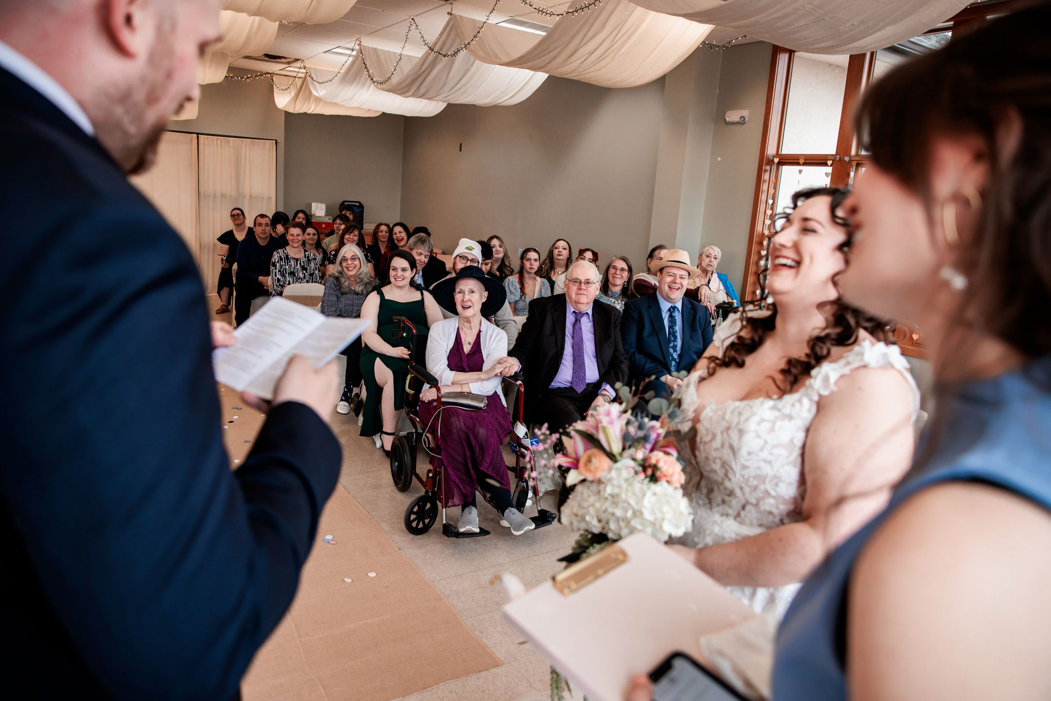 During the wedding ceremony the guests enjoy the bride and groom reading their vows.