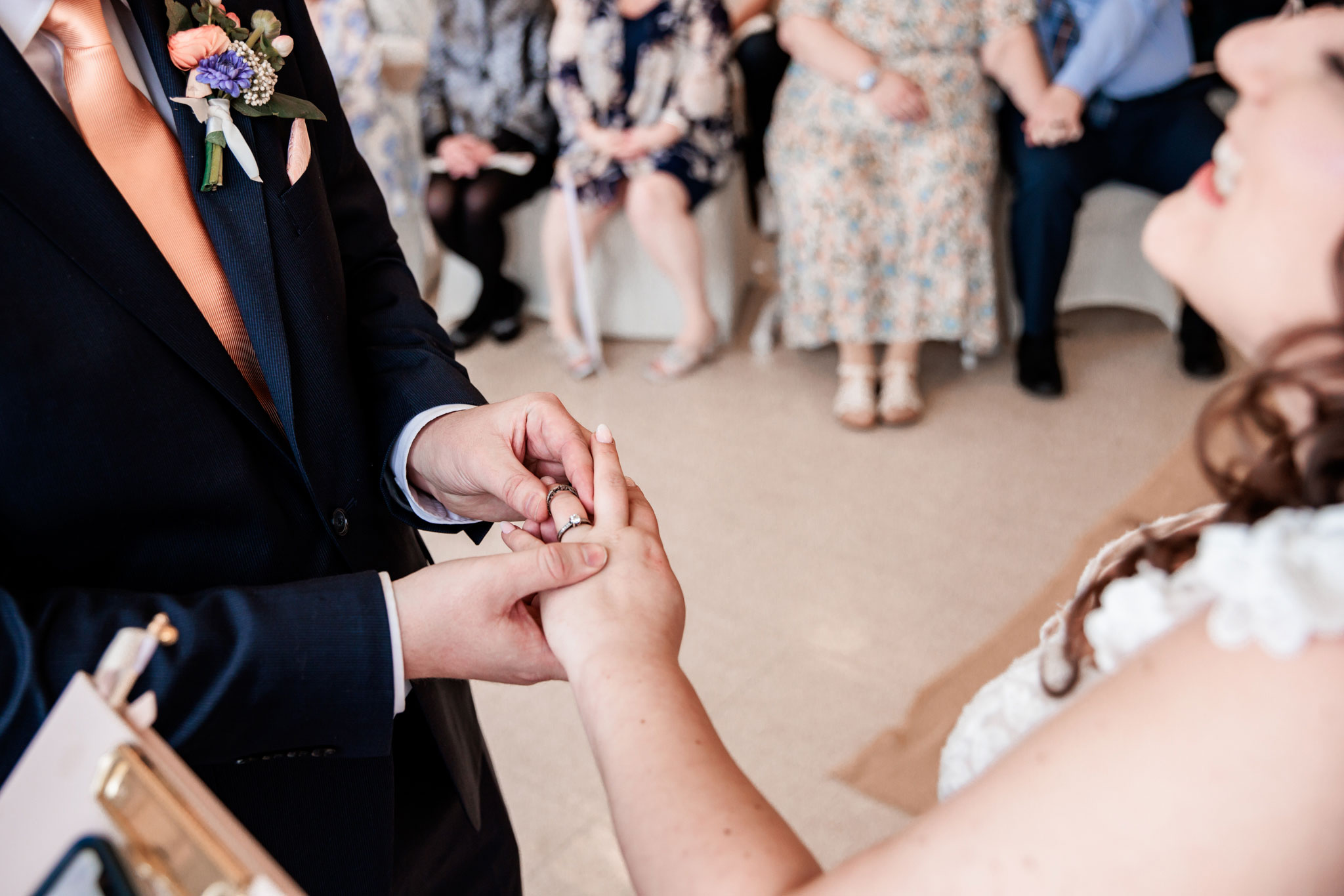 The groom places the ring on his brides finger during the ceremony.