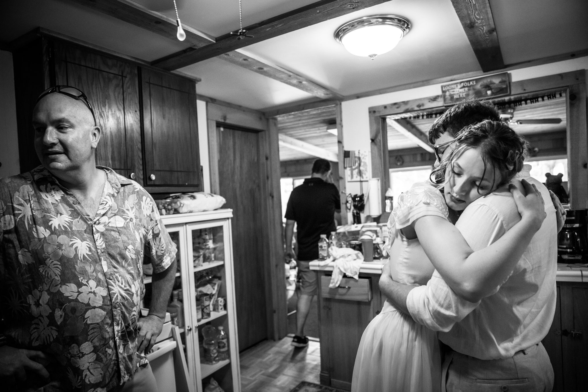 Bride embracing her groom in the kitchen during the reception.