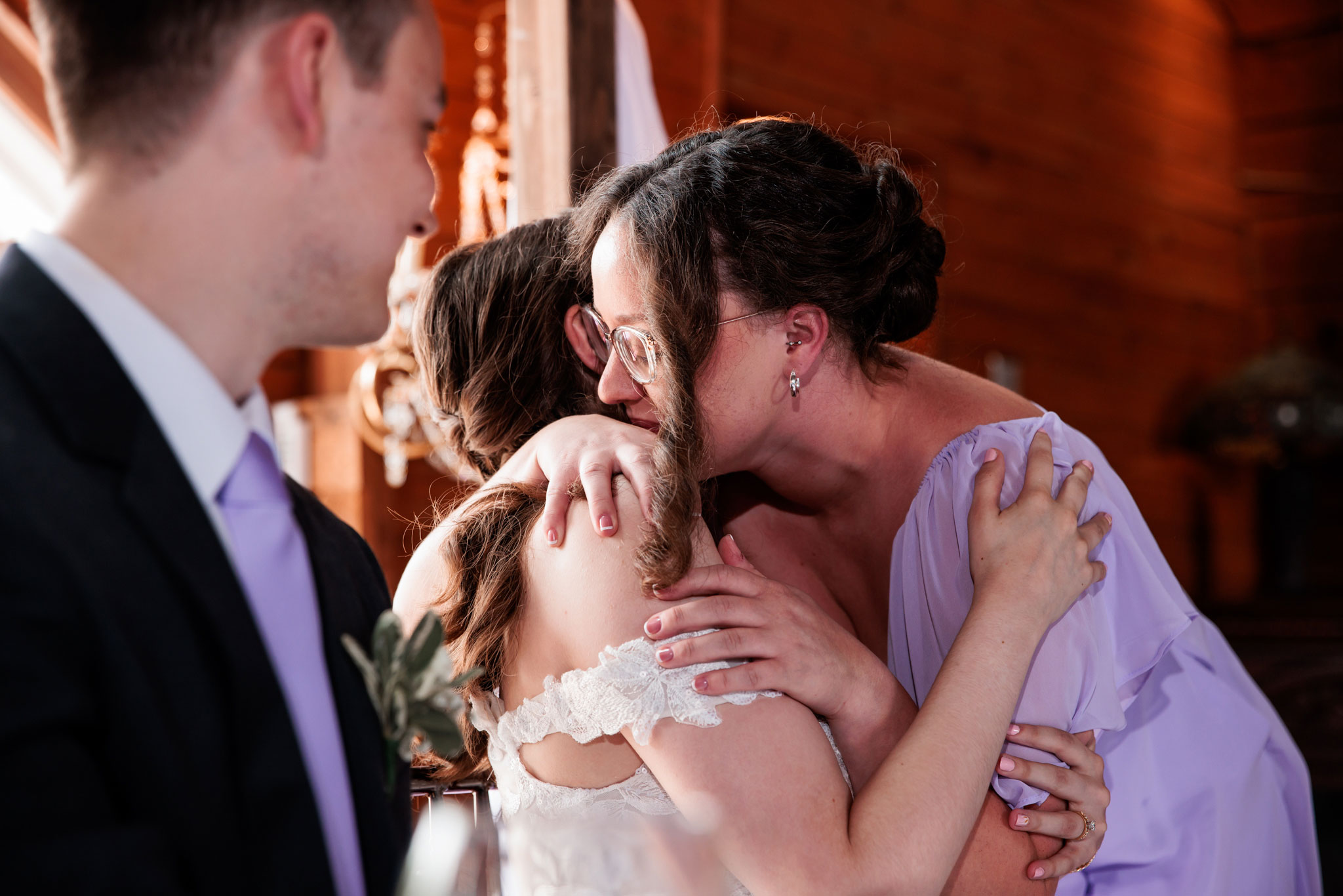 An intimate hug between bride and her maid of honor.