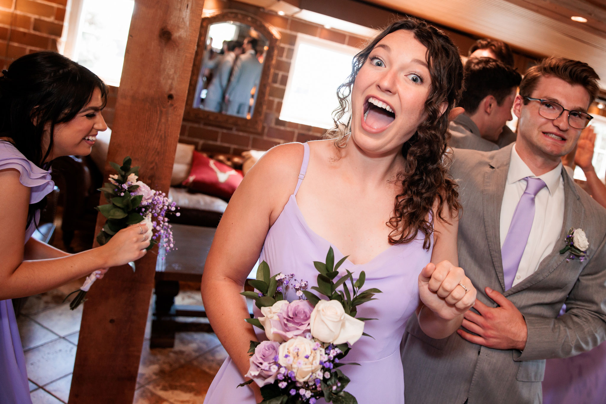 A bridesmaid beaming with a big smile after the ceremony.