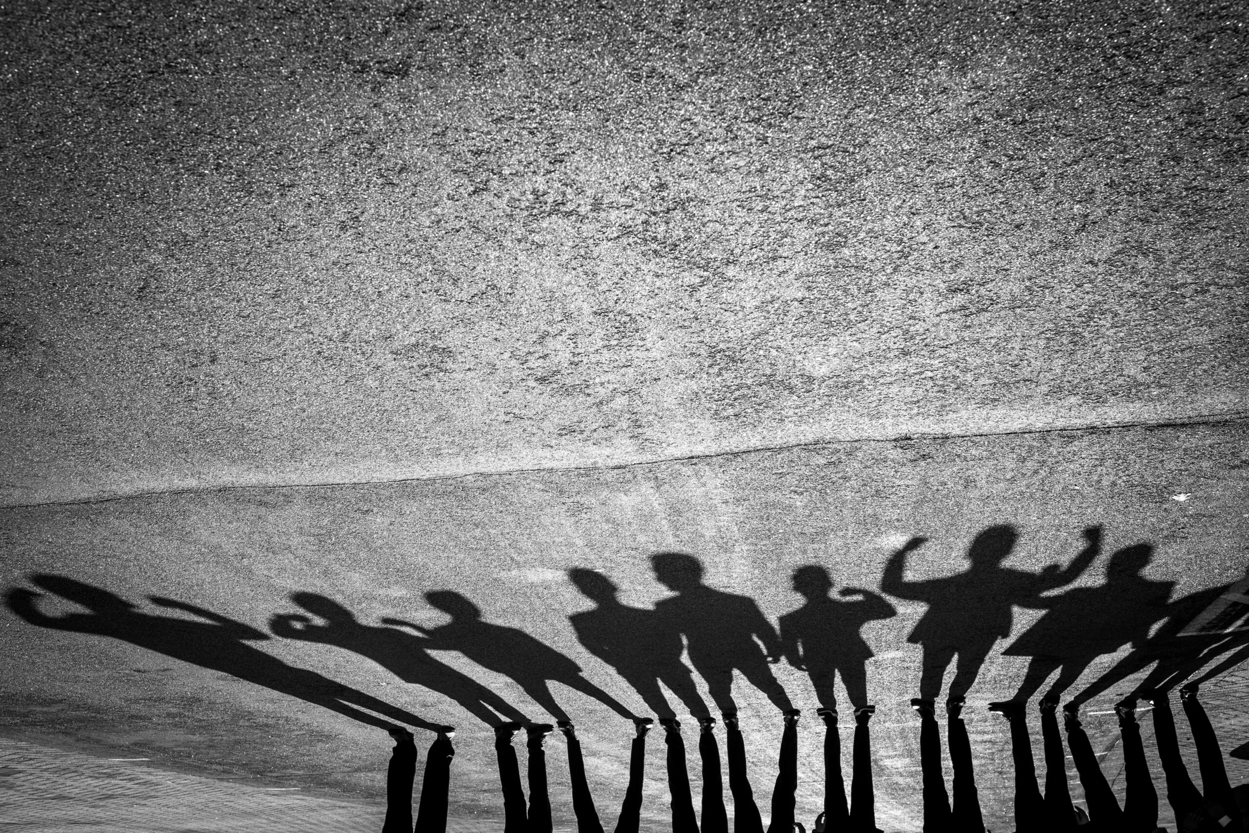 Groomsmen shadows on the pavement.
