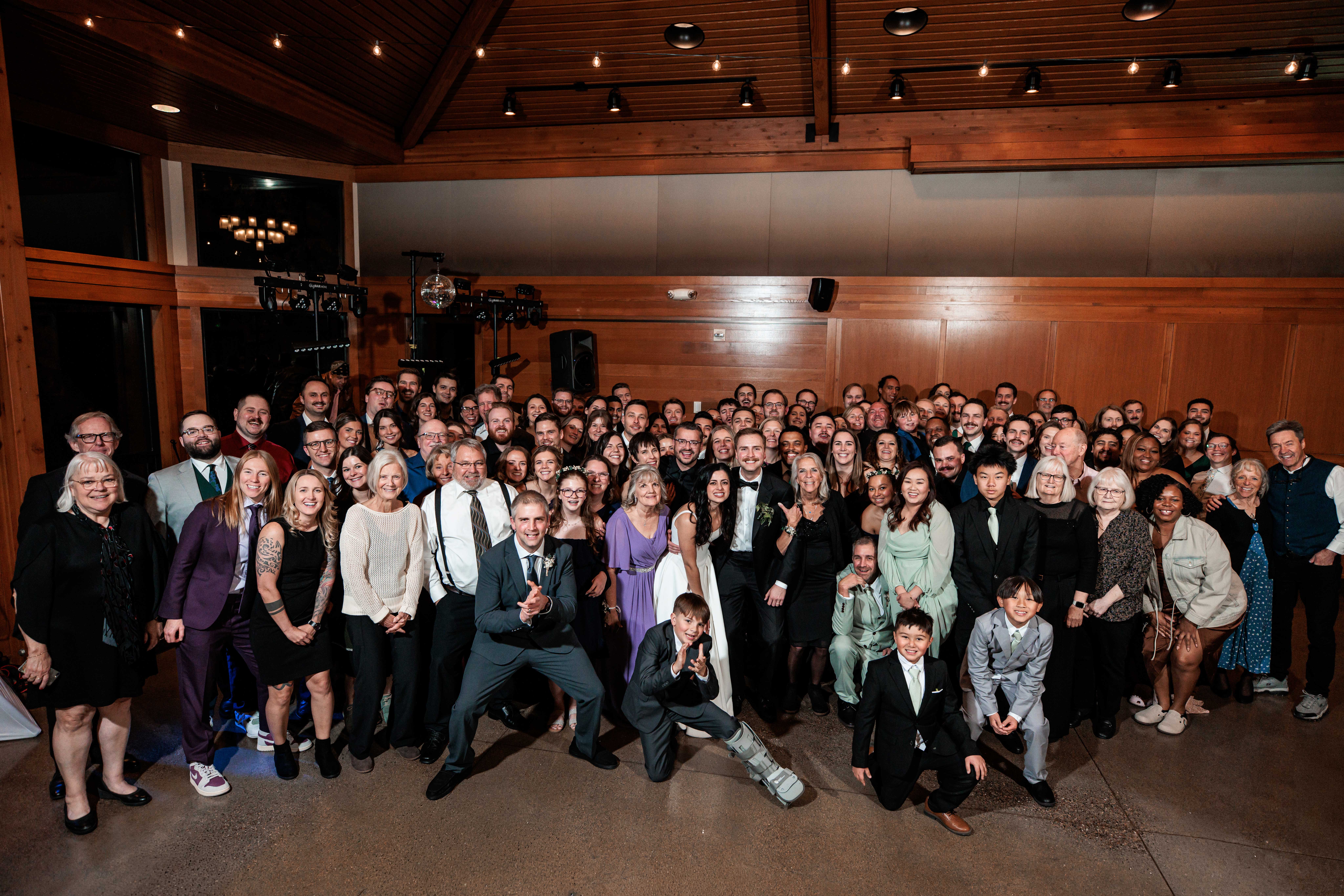 A full wedding reception group photo on the dance floor inside Silverwood park wedding venue.