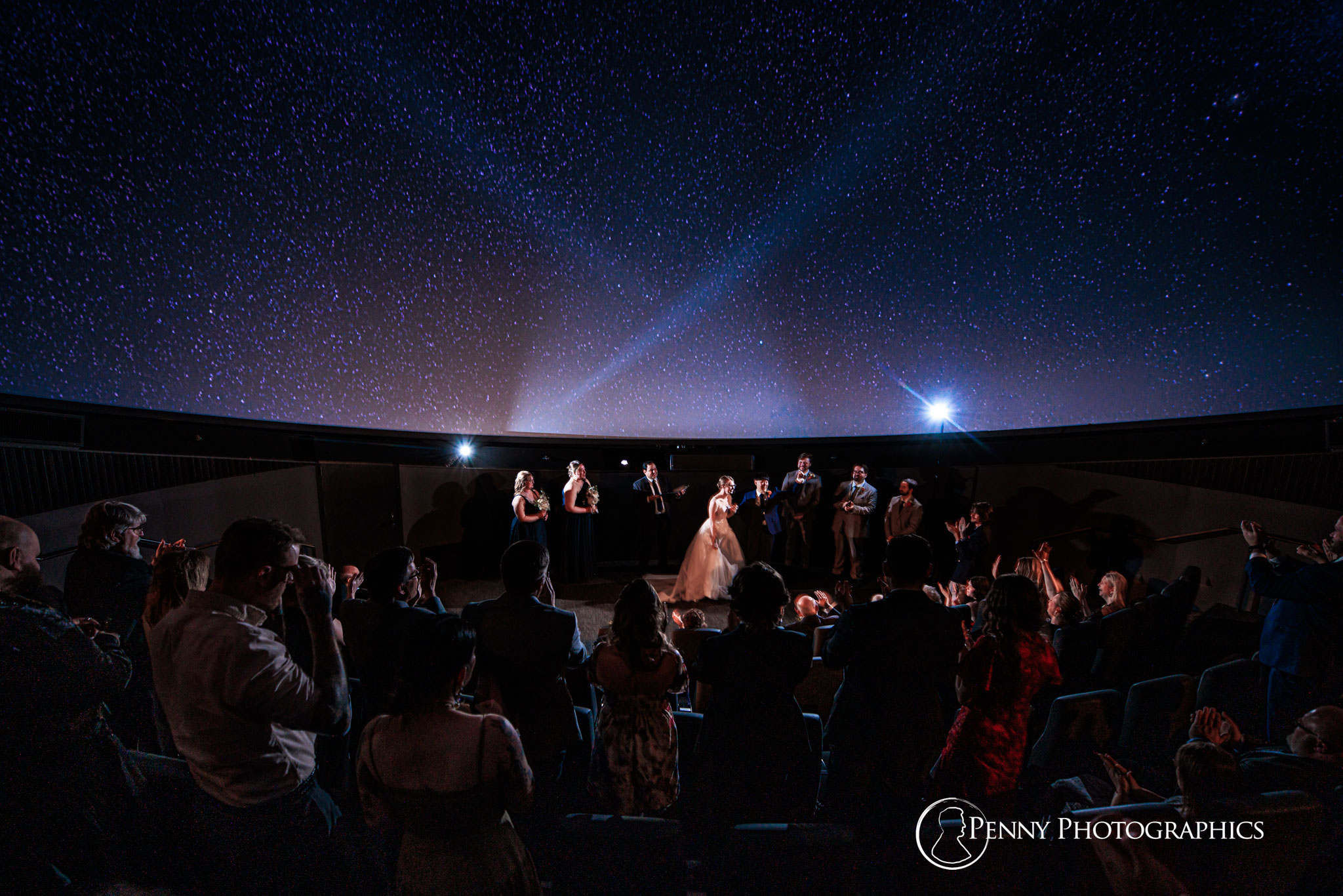 A wedding ceremony in the night sky of the planetarium in the Bell museum. 